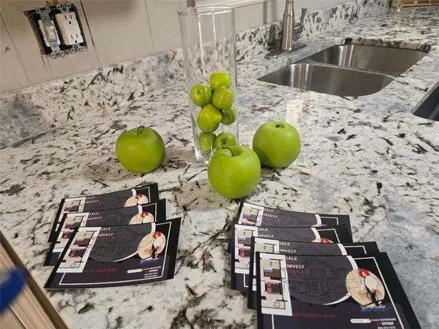 a view of living room with table and chairs