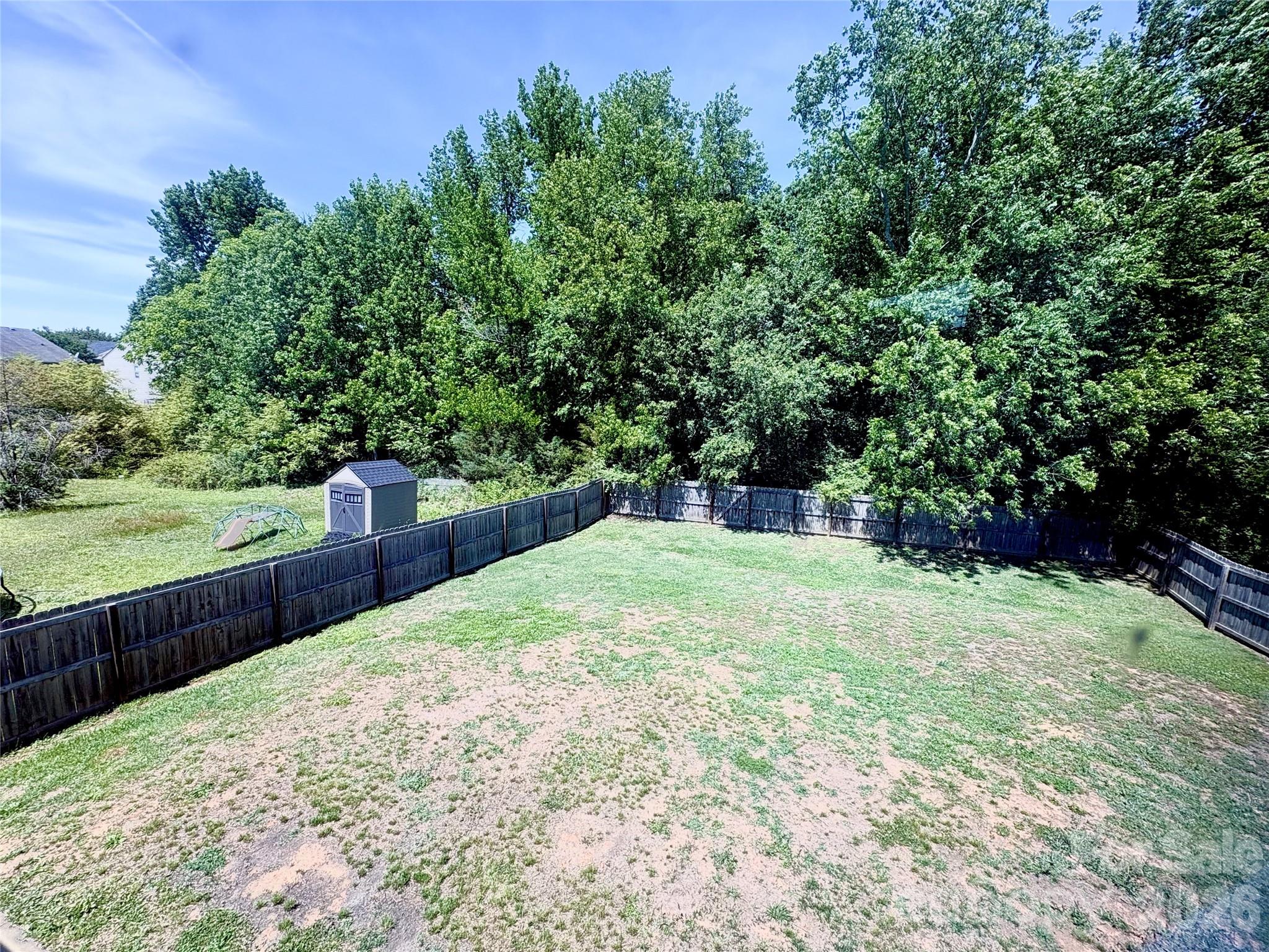 2514 Spring Breeze Way Monroe, NC 28110 - Photo 22 of 25 a view of a backyard with a garden