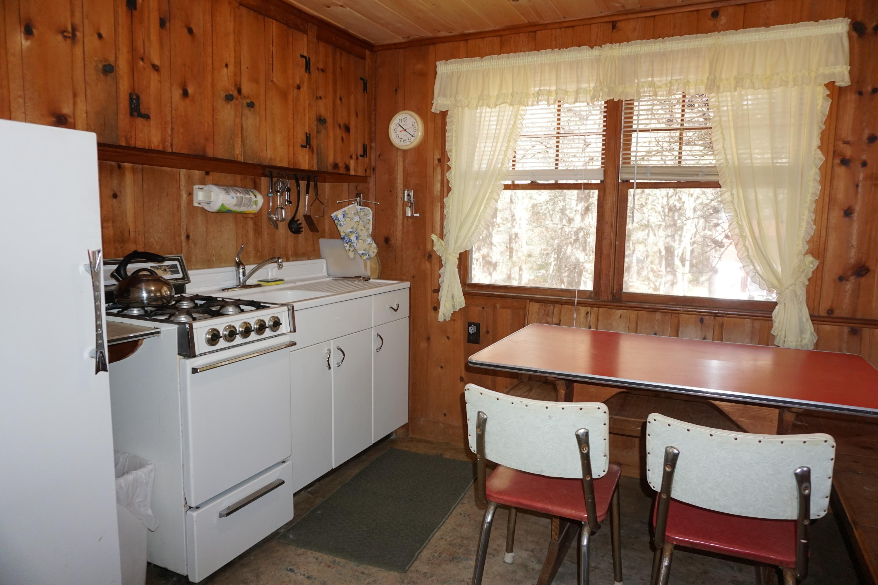 124 Castle Road, Unit 4 Truro, MA 02666 - Photo 14 of 20 a kitchen with a stove and chairs