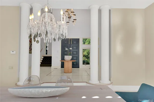 a view of dining room with chandelier and glass door