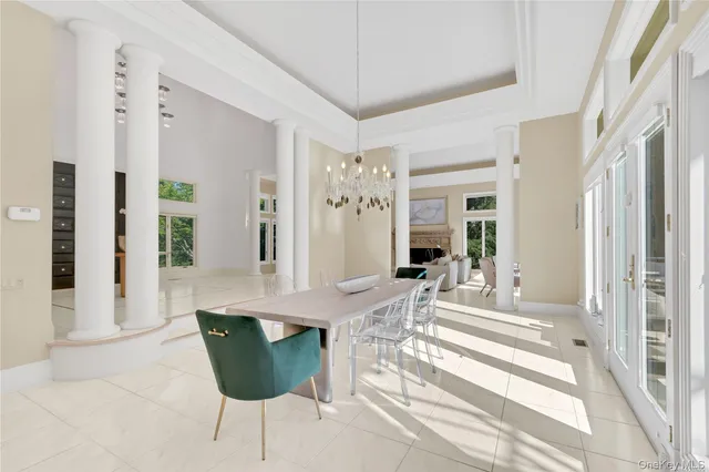 a view of a dining room with furniture and a large window