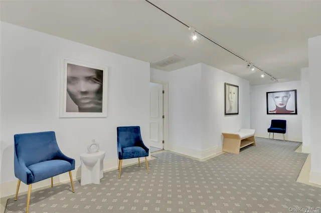 a living room with furniture and painting on the wall