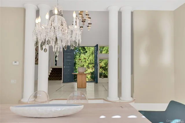a view of a dining room with floor to ceiling window and potted plants