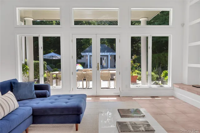 a view of a house with backyard and sitting area