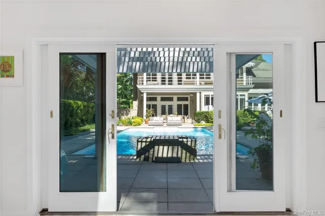 a view of a living room and balcony with furniture