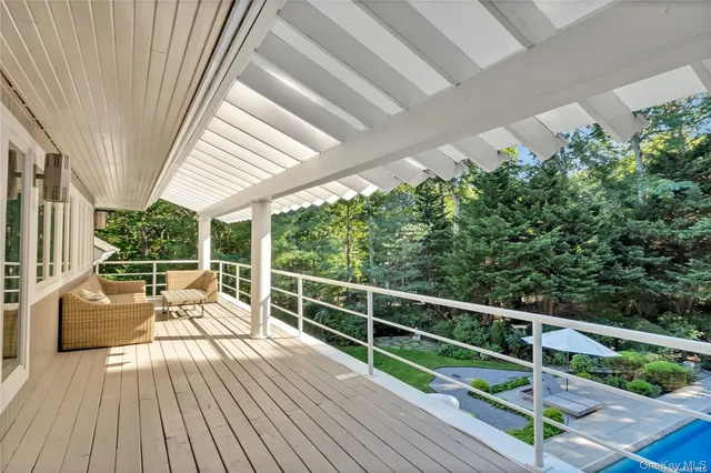 a view of balcony with furniture and wooden floor