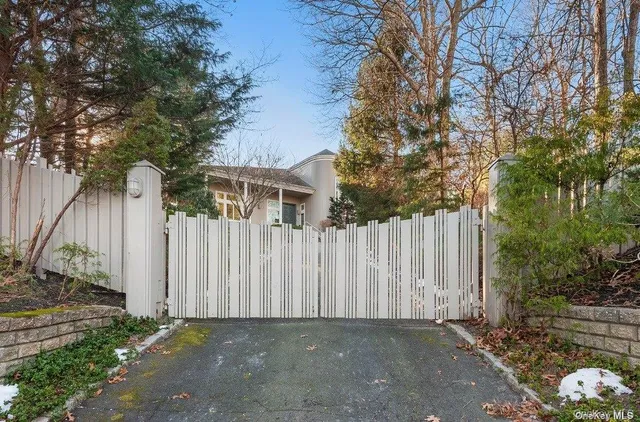 a view of small yard with white fence