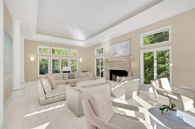 a living room with furniture a fireplace and a large window