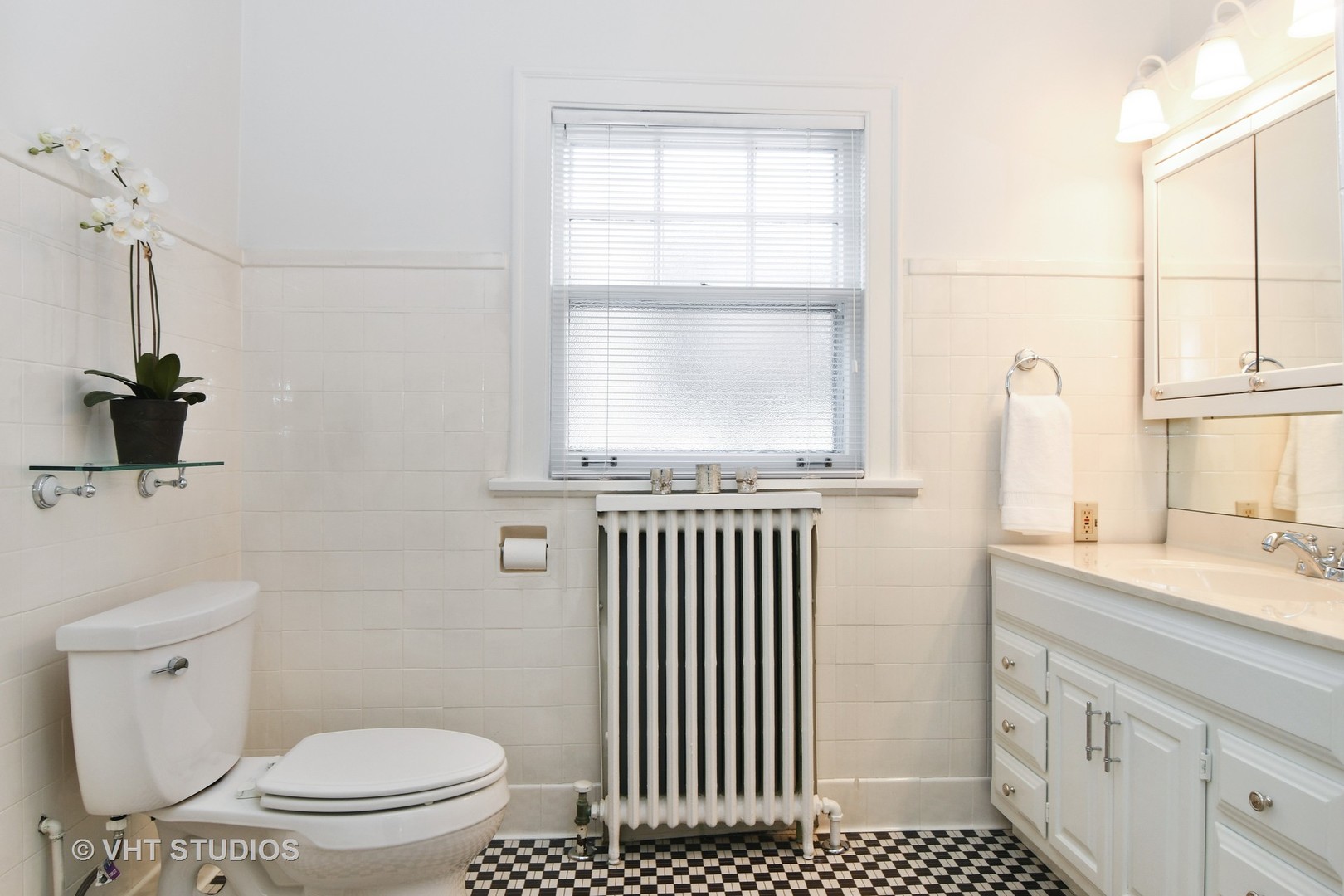 141 Robsart Place Kenilworth, IL 60043 - Photo 27 of 38 a bathroom with a granite countertop sink a toilet and a window