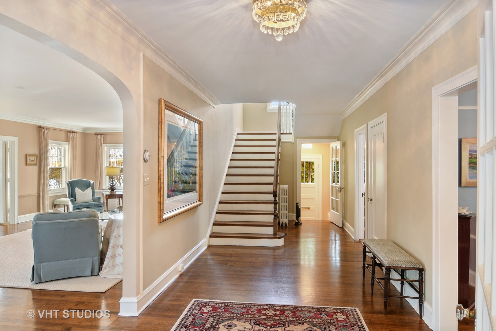141 Robsart Place Kenilworth, IL 60043 - Photo 6 of 38 a view of a hallway to a livingroom with wooden floor and furniture