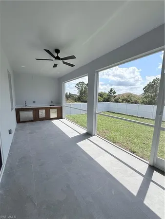 a view of an empty room with a floor to ceiling window and a ocean view