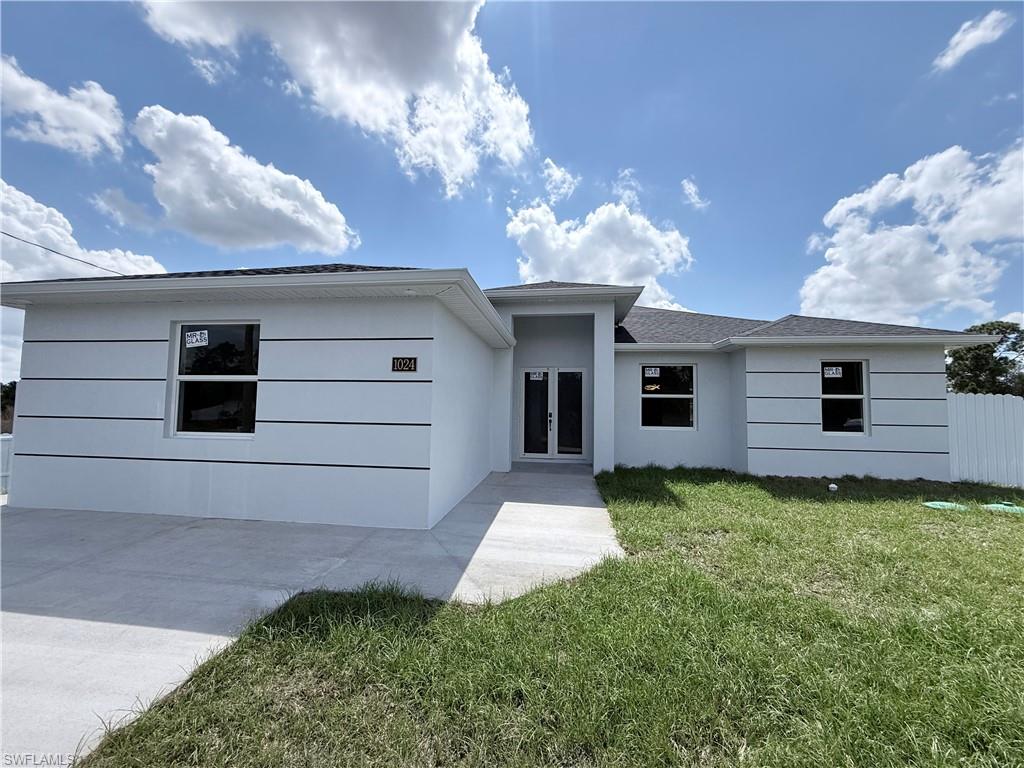 1024 Hatfield Street Lehigh Acres, FL 33974 - Photo 2 of 3 View of front of house with french doors