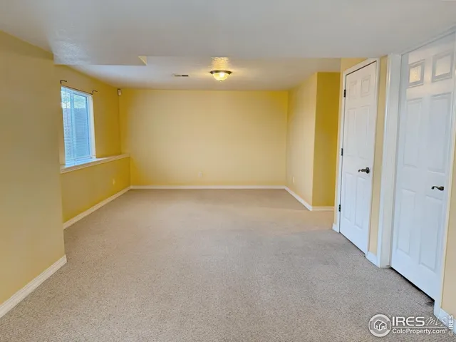 a view of a hallway with wooden shelves