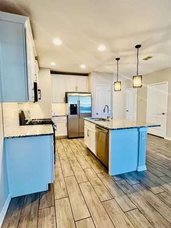 a view of kitchen with sink microwave and stove
