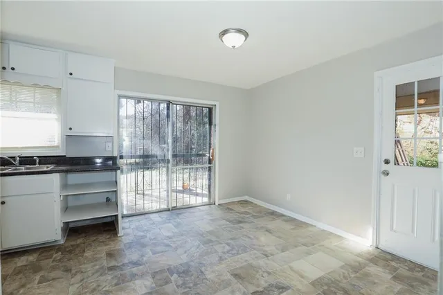 an empty room with wooden floor and closet