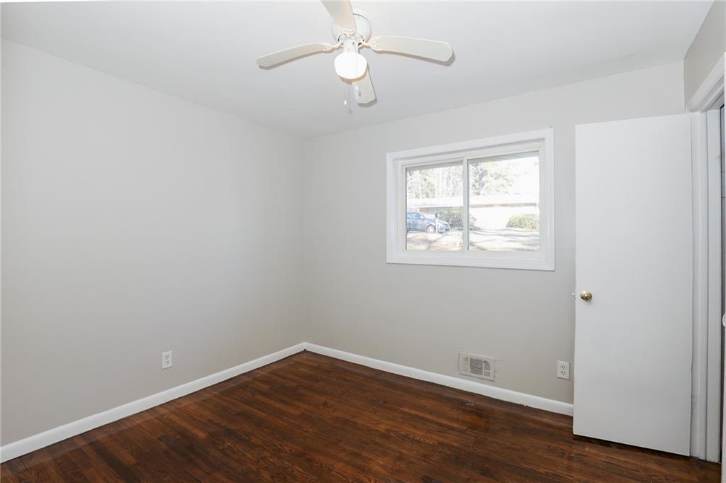 2707 Cavalier Way Decatur, GA 30034 - Photo 6 of 13 a view of an empty room with wooden floor and a window