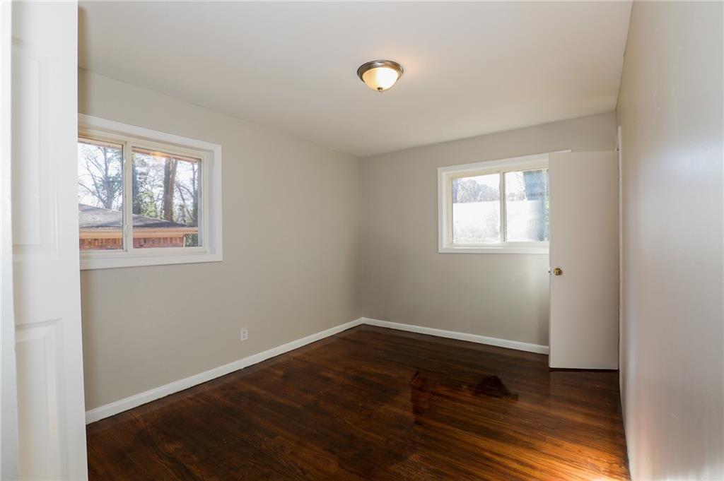 2707 Cavalier Way Decatur, GA 30034 - Photo 8 of 13 an empty room with wooden floor and windows