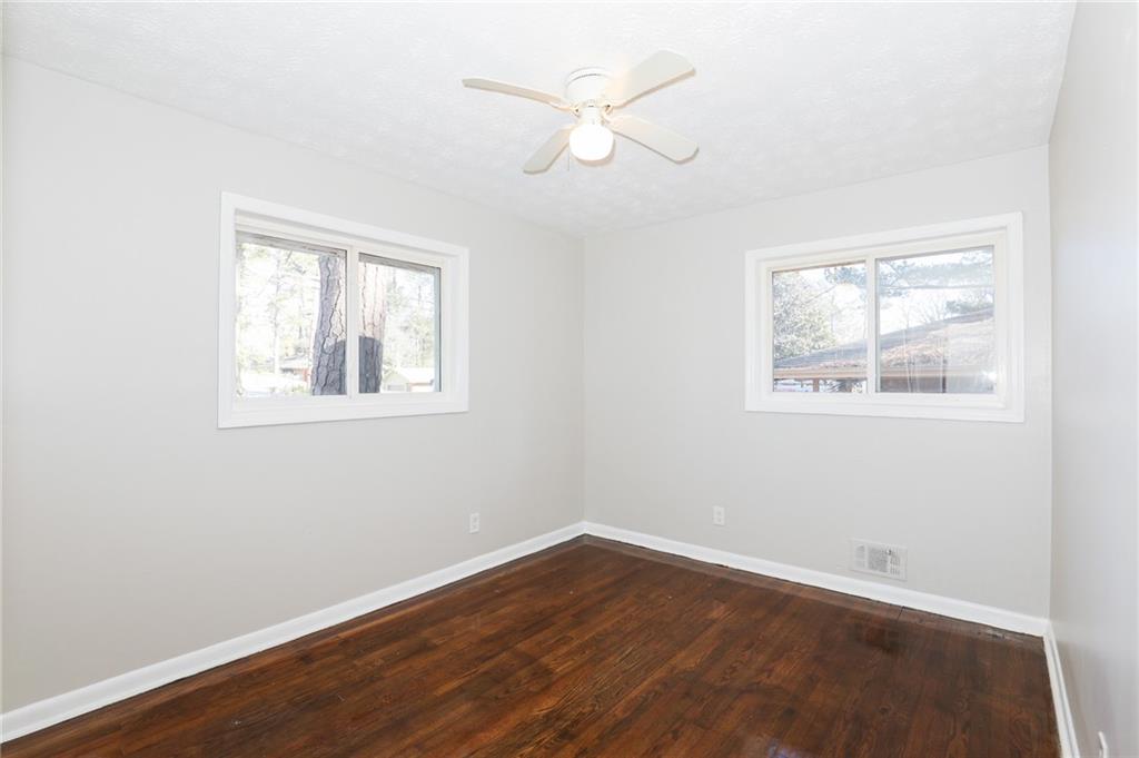 2707 Cavalier Way Decatur, GA 30034 - Photo 9 of 13 a view of an empty room with wooden floor and a window