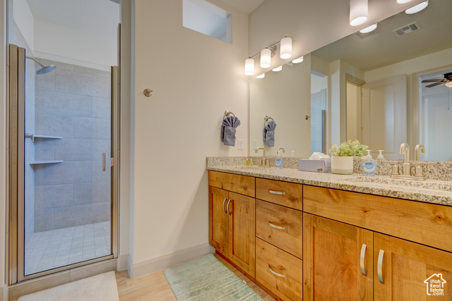 1329 Paseos Street Washington, UT 84780 - Photo 15 of 35 Bathroom with double vanity, a shower stall, a ceiling fan, and light wood finished floors