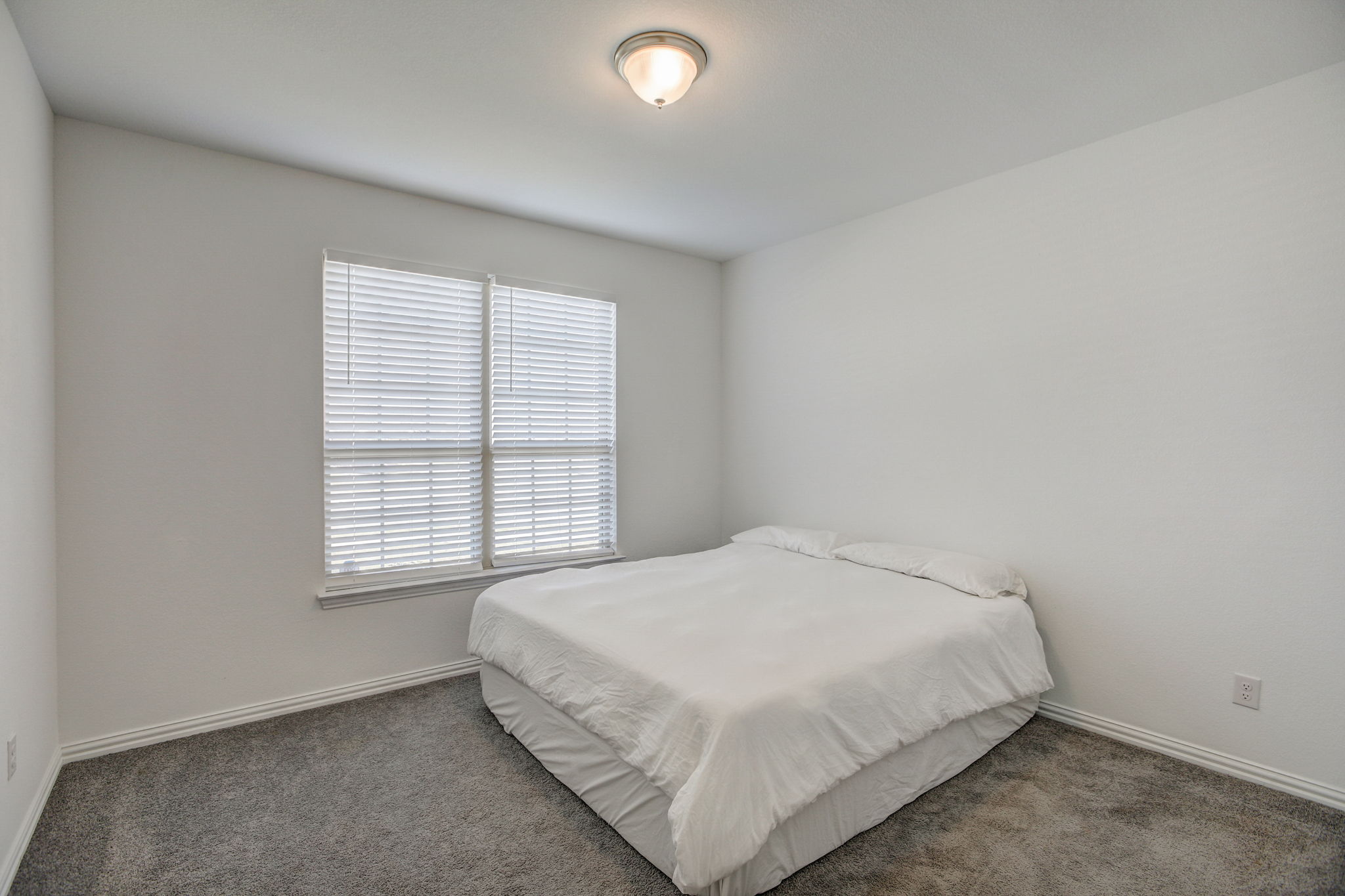 308 Monteforte Road Hutto, TX 78634 - Photo 12 of 32 a large bed sitting in a bedroom next to a window