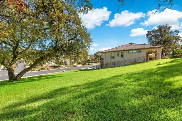 a view of yard with swimming pool and green space