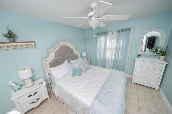 a bed room with a bed and a chandelier