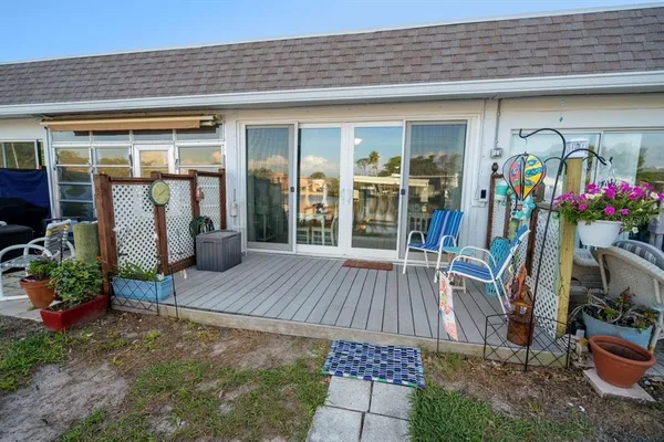an outdoor sitting area with furniture and garden