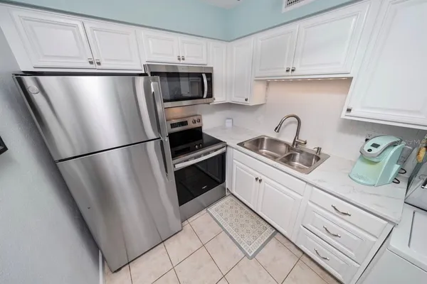 a kitchen with stainless steel appliances a refrigerator sink and stove