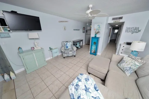 a living room with furniture and dining table