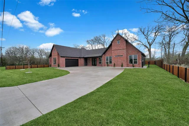 a front view of house with yard and green space
