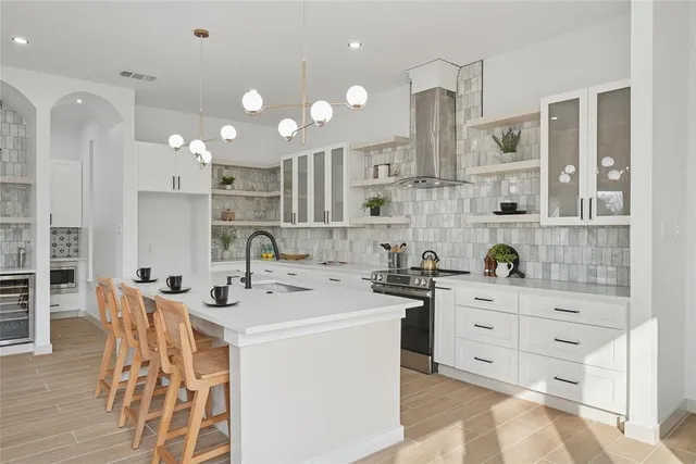 a kitchen with stainless steel appliances kitchen island granite countertop a sink and cabinets