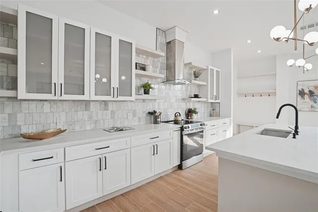 a kitchen with cabinets a sink and appliances