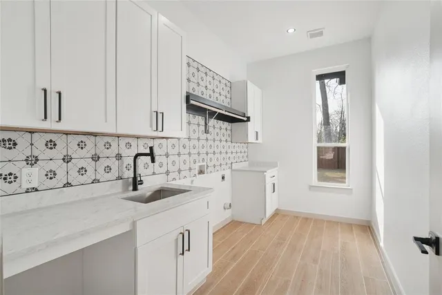 a kitchen with sink a cabinets and window