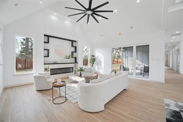 a living room with furniture and a wooden floor