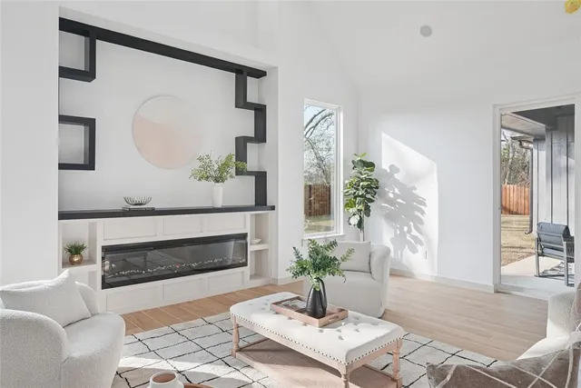 a living room with furniture a potted plant and a fireplace