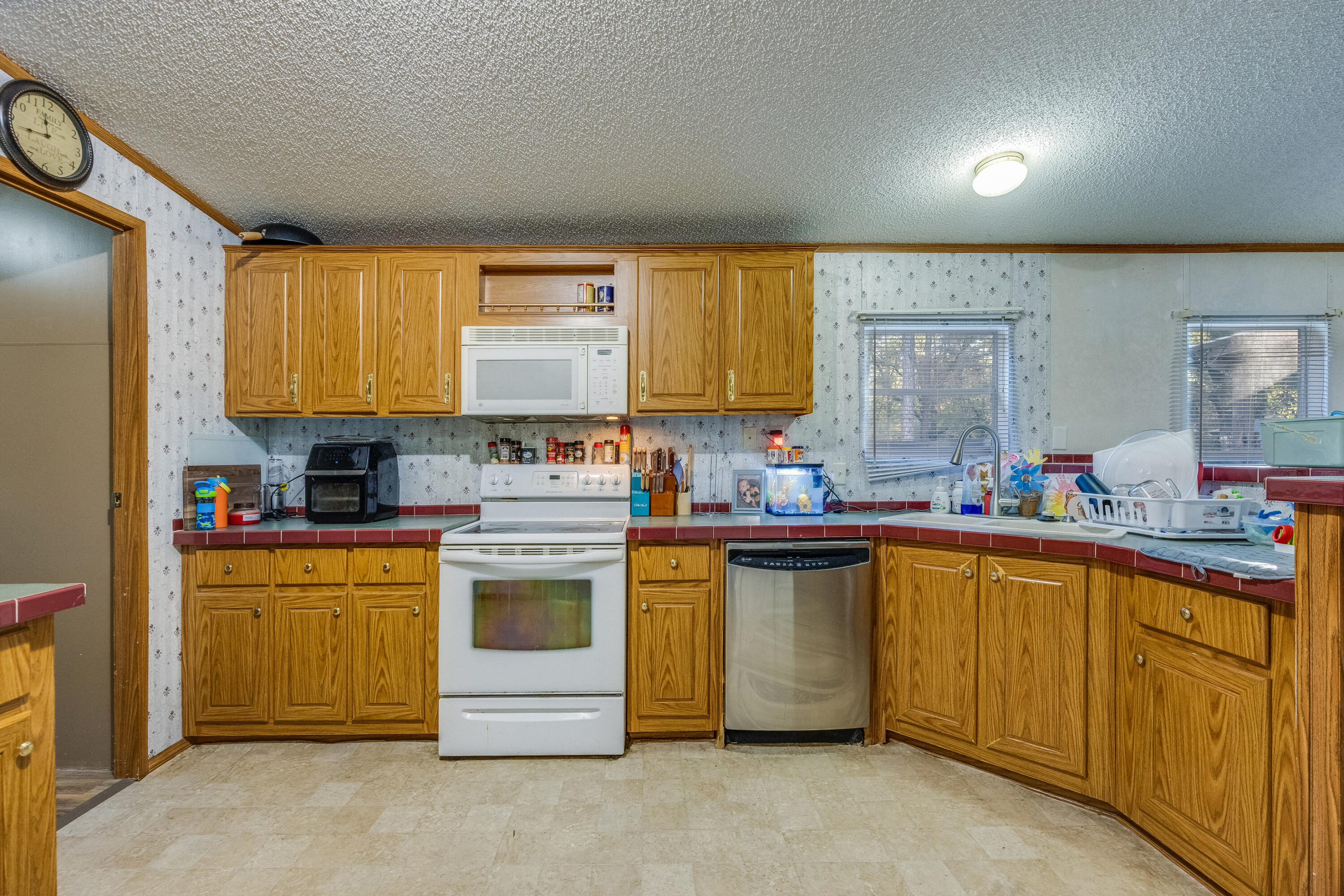 1953 Cotton Creek Road Baker, FL 32531 - Photo 11 of 38 a kitchen with a stove sink and cabinets