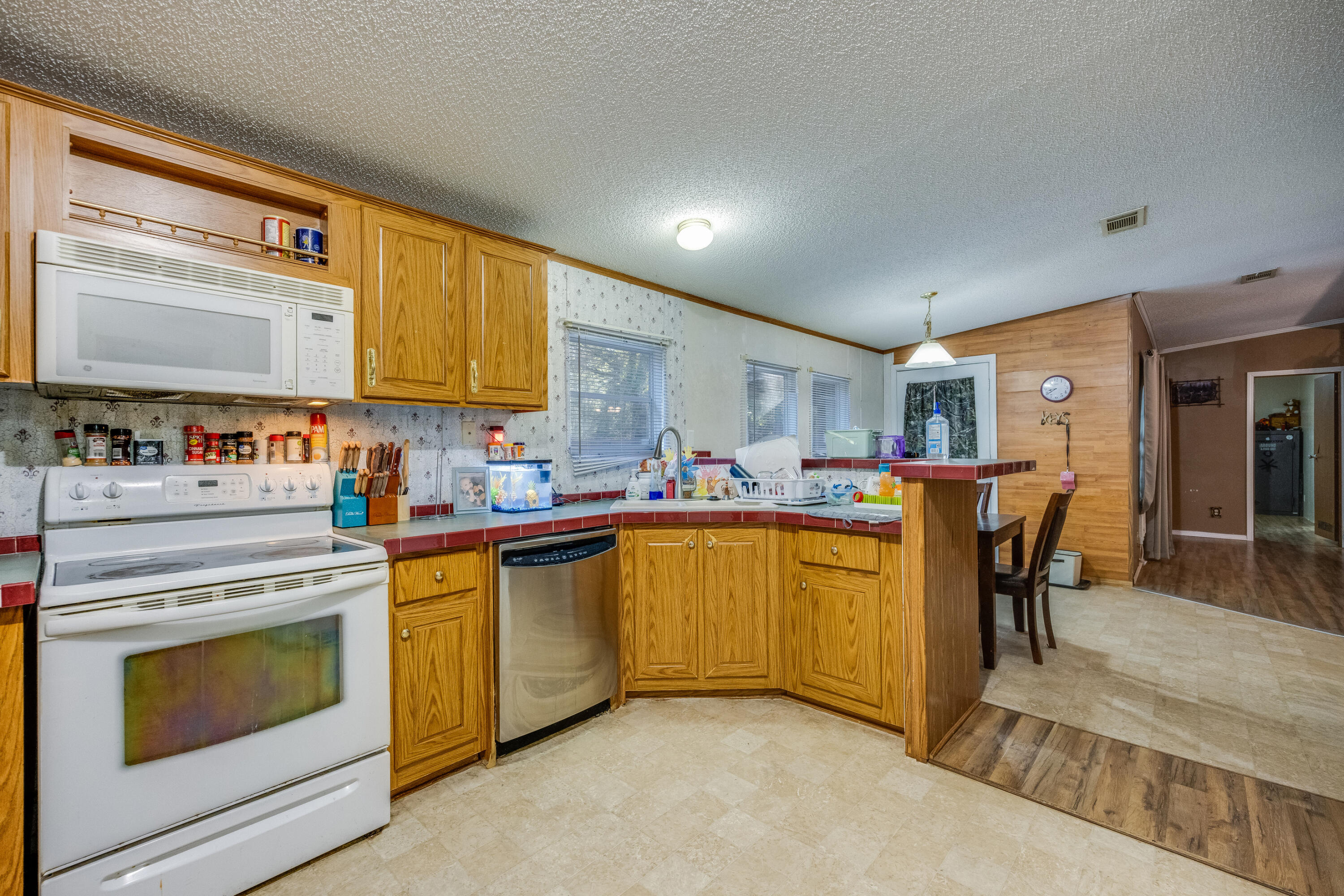 1953 Cotton Creek Road Baker, FL 32531 - Photo 12 of 38 a kitchen with stainless steel appliances granite countertop a stove a sink and a refrigerator