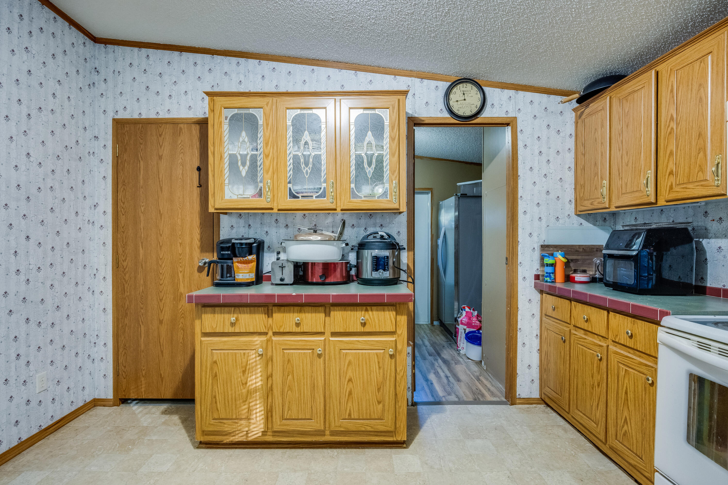 1953 Cotton Creek Road Baker, FL 32531 - Photo 13 of 38 a kitchen with stainless steel appliances granite countertop a refrigerator and a stove top oven