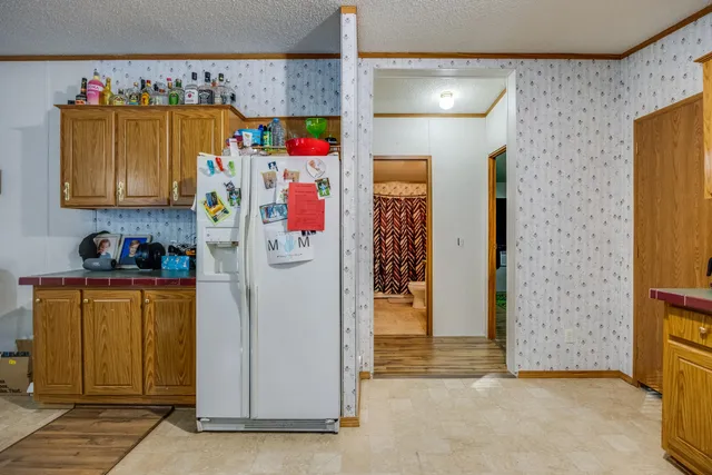 a utility room with fridge and closet
