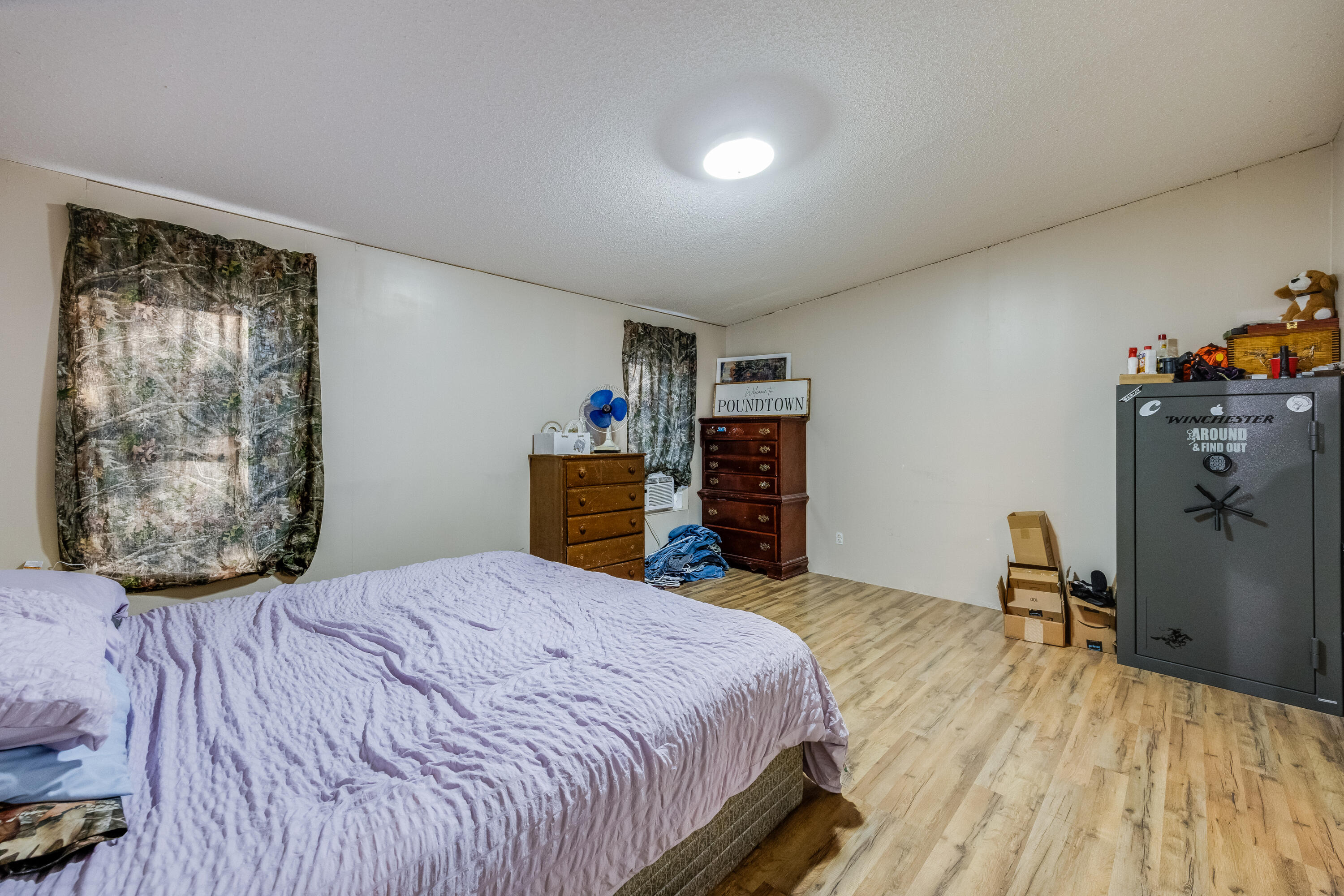 1953 Cotton Creek Road Baker, FL 32531 - Photo 16 of 38 a bedroom with a bed and wooden floor