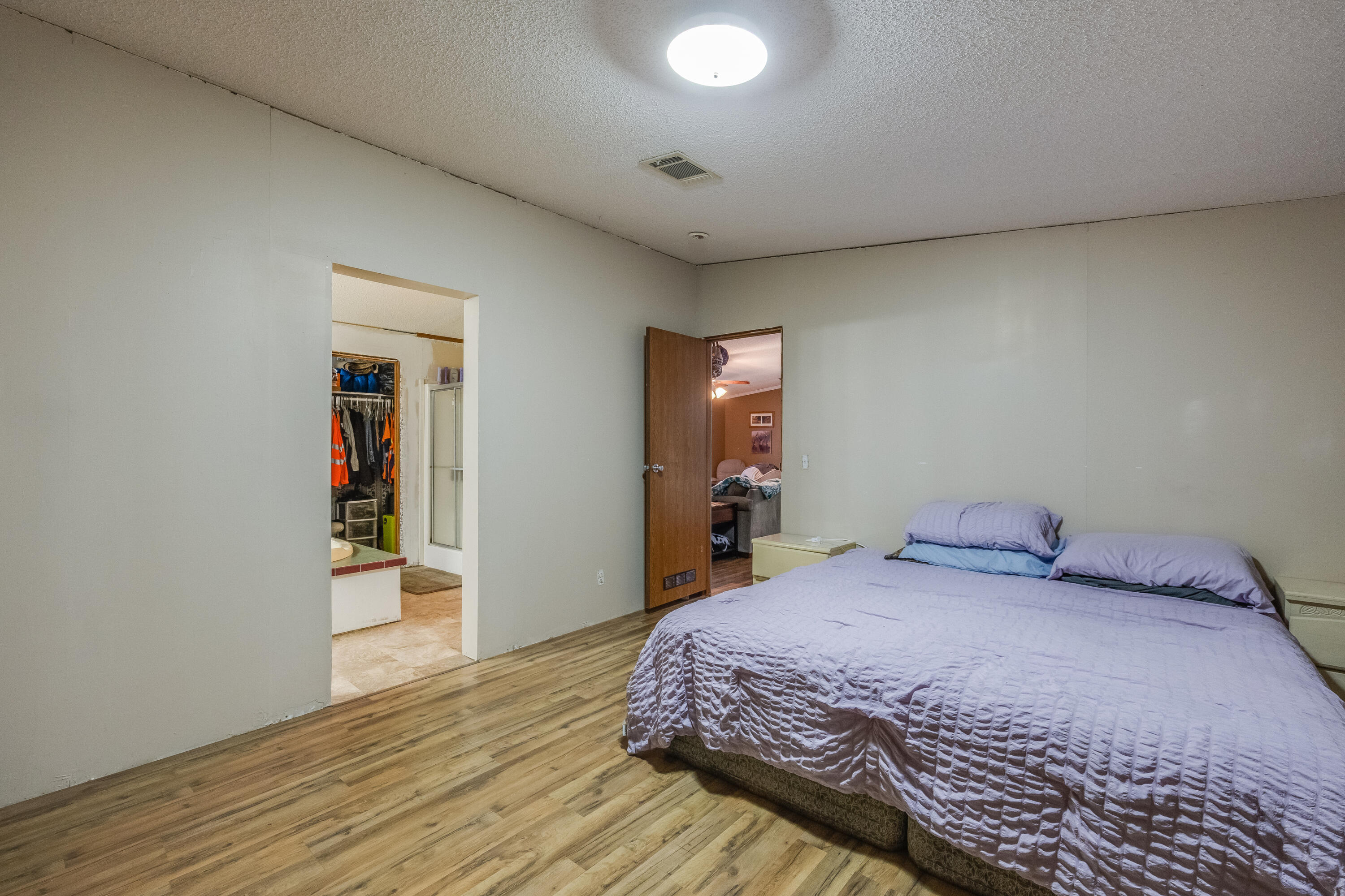 1953 Cotton Creek Road Baker, FL 32531 - Photo 17 of 38 a bedroom with a bed and a wooden floor