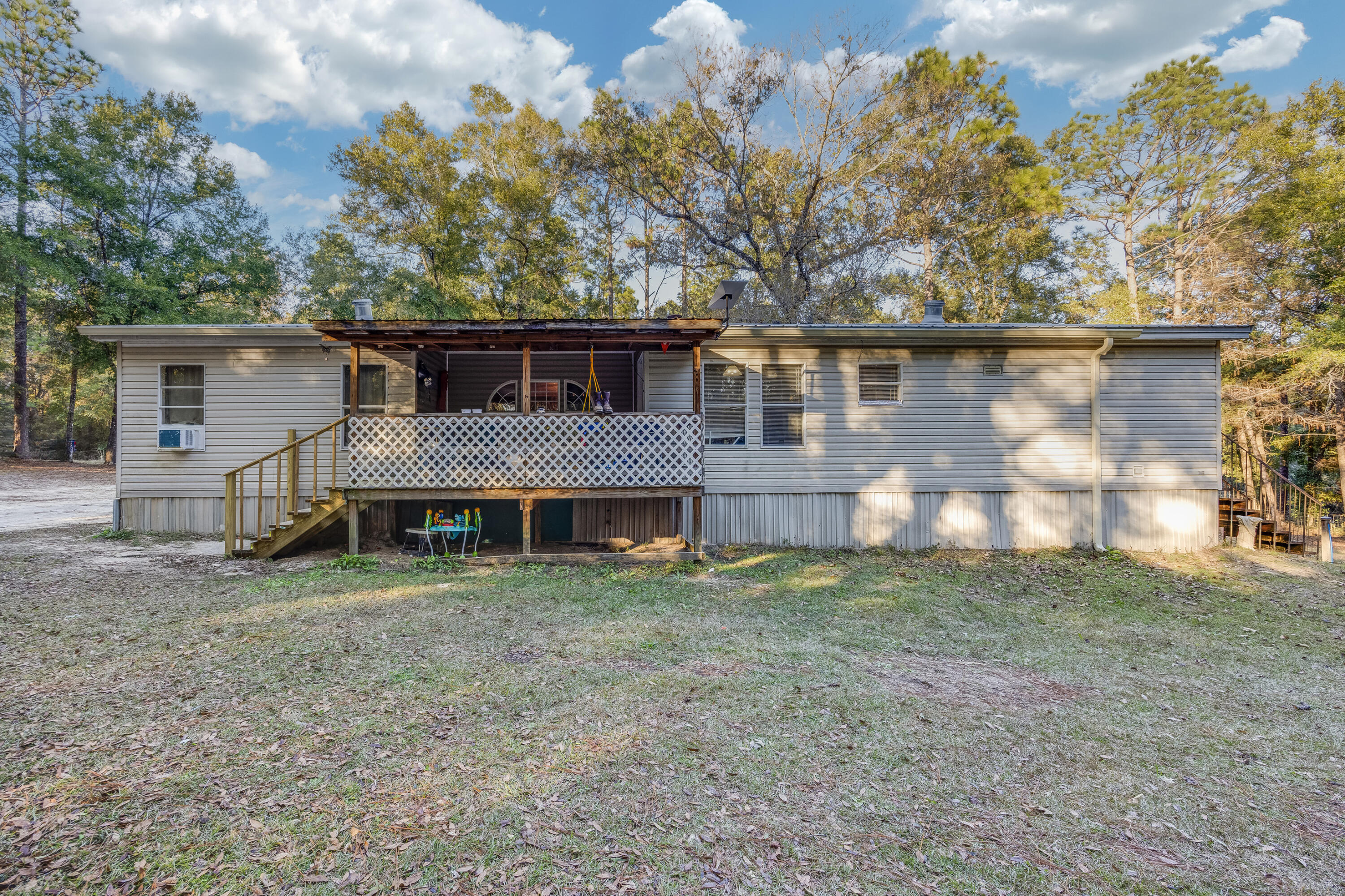 1953 Cotton Creek Road Baker, FL 32531 - Photo 27 of 38 a view of a house with a yard