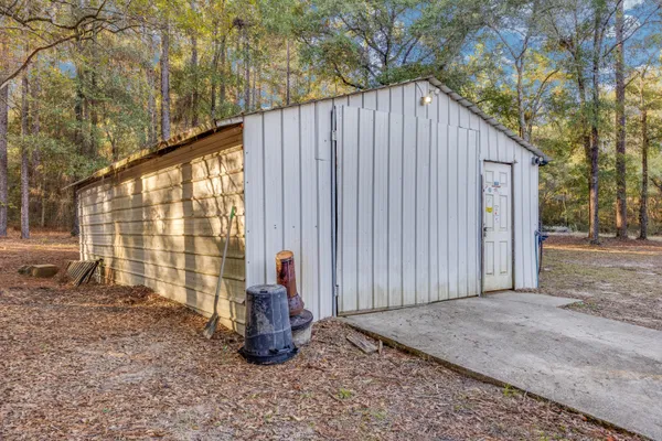 a view of backyard with wooden fence and floor