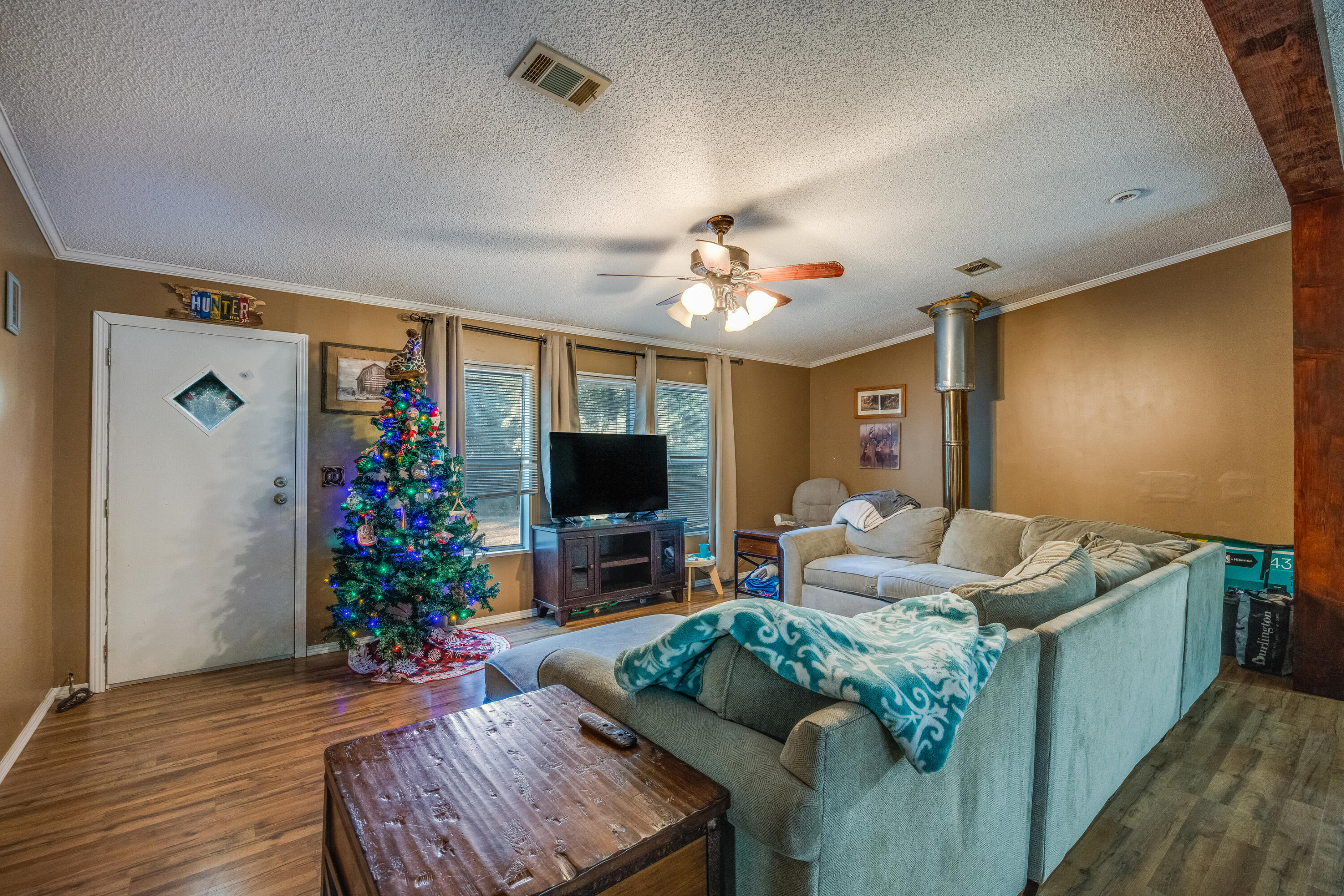 1953 Cotton Creek Road Baker, FL 32531 - Photo 4 of 38 a living room with furniture and a flat screen tv