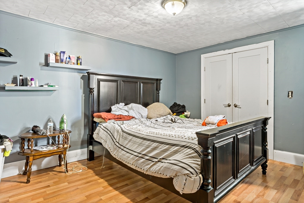 163 Warren Street Fall River, MA 02721 - Photo 18 of 39 a bedroom with a bed and a table in it