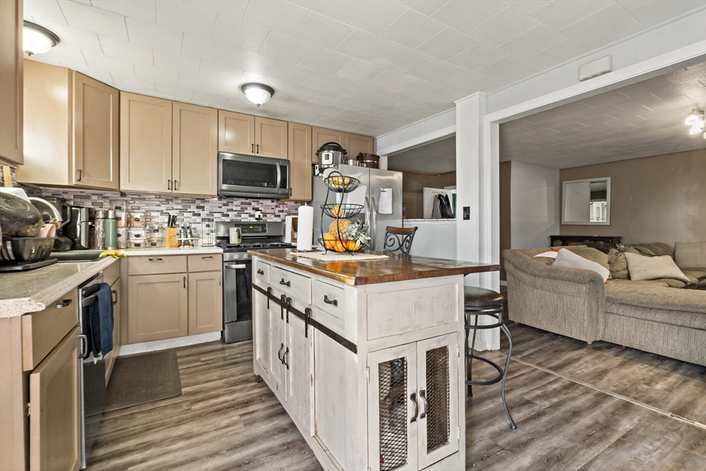 163 Warren Street Fall River, MA 02721 - Photo 21 of 39 a kitchen with granite countertop a sink stove and cabinets