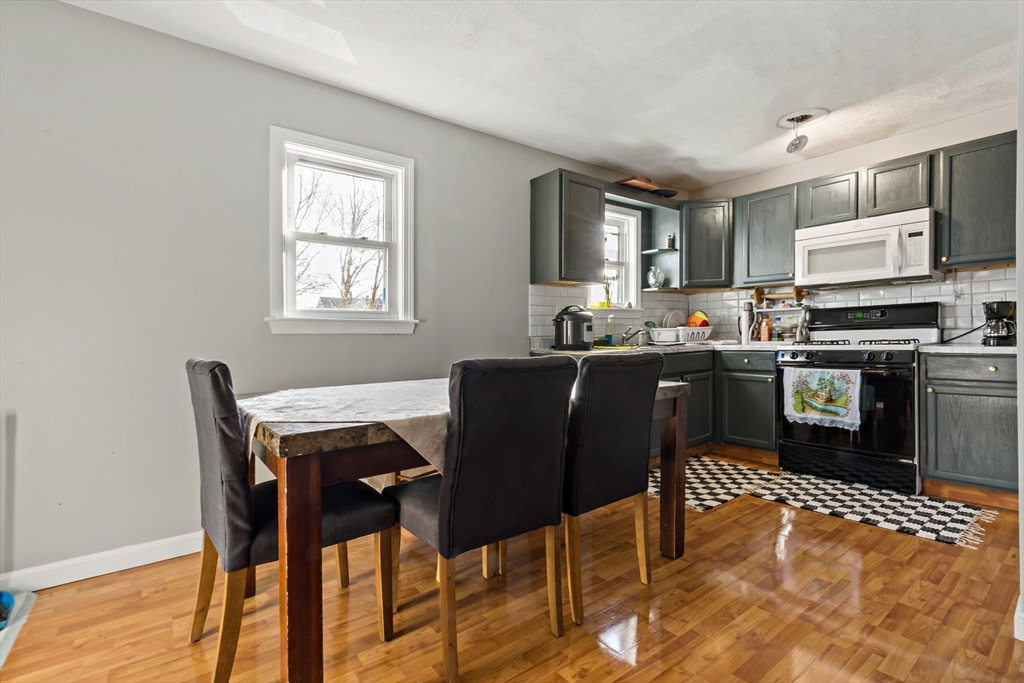 163 Warren Street Fall River, MA 02721 - Photo 29 of 39 a kitchen with stainless steel appliances granite countertop a sink a stove a table and chairs