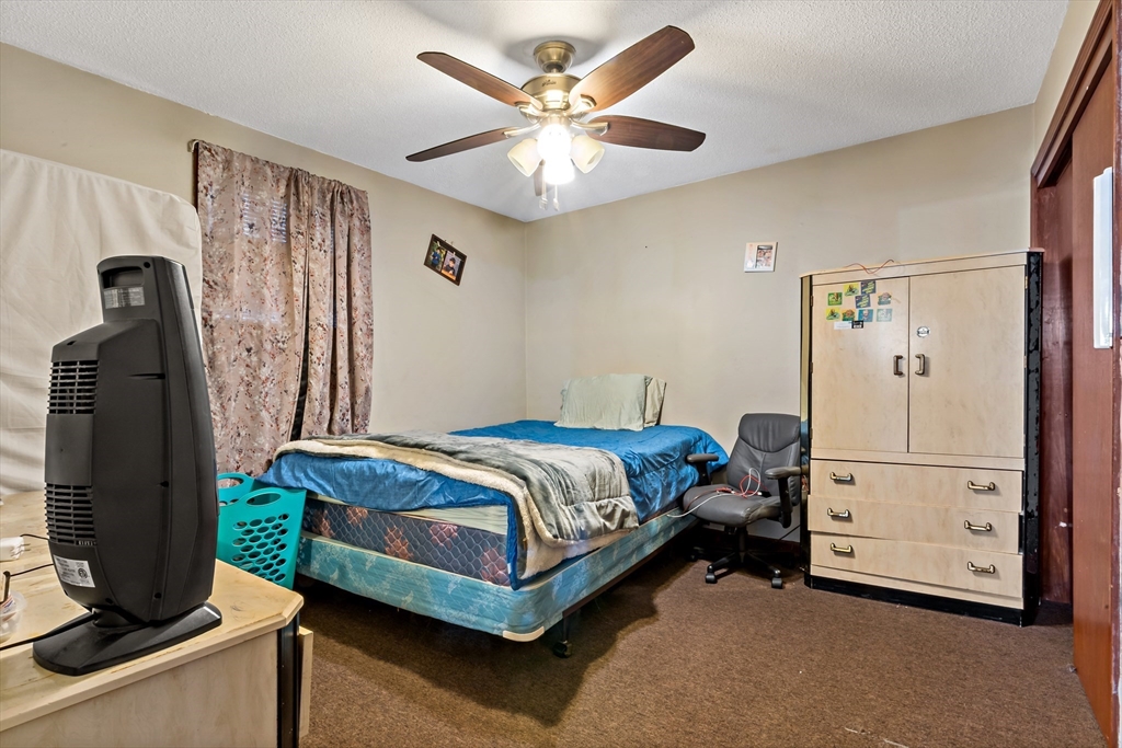 163 Warren Street Fall River, MA 02721 - Photo 6 of 39 a bedroom with a bed and a table