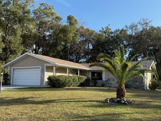 6506 East Mockingbird Lane Inverness, FL 34452 - Photo 1 of 9 a front view of a house with a garden and trees