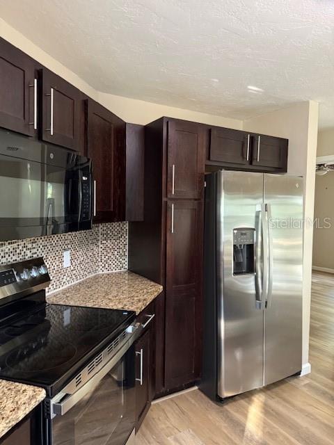 6506 East Mockingbird Lane Inverness, FL 34452 - Photo 3 of 9 a kitchen with stainless steel appliances granite countertop a refrigerator and a stove